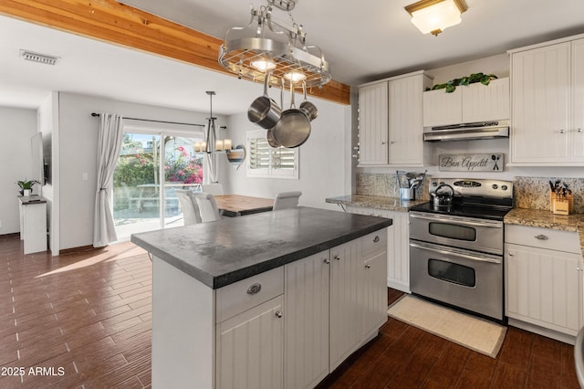 kitchen with double oven range, dark hardwood / wood-style floors, pendant lighting, and a kitchen island