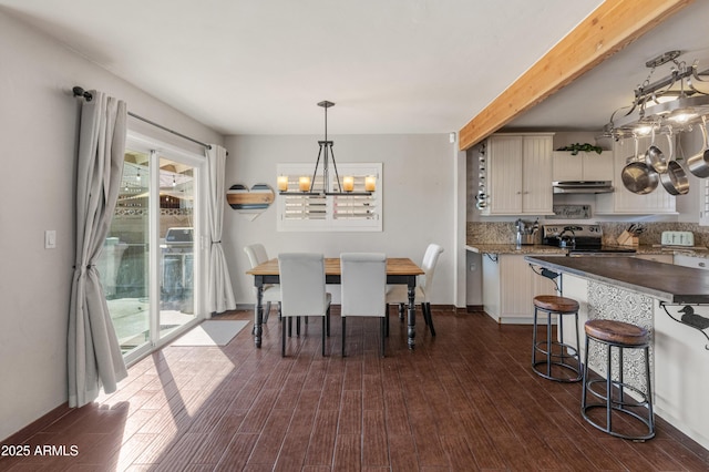 dining room featuring dark hardwood / wood-style flooring and a notable chandelier