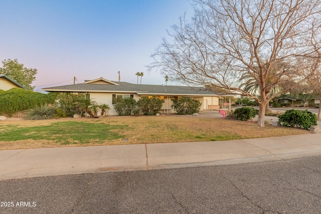 ranch-style home featuring a yard