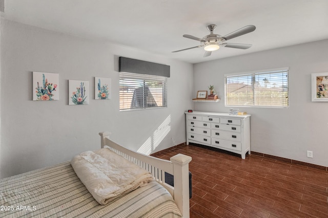 bedroom with ceiling fan and multiple windows