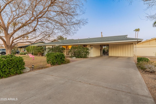 single story home featuring a garage and a carport