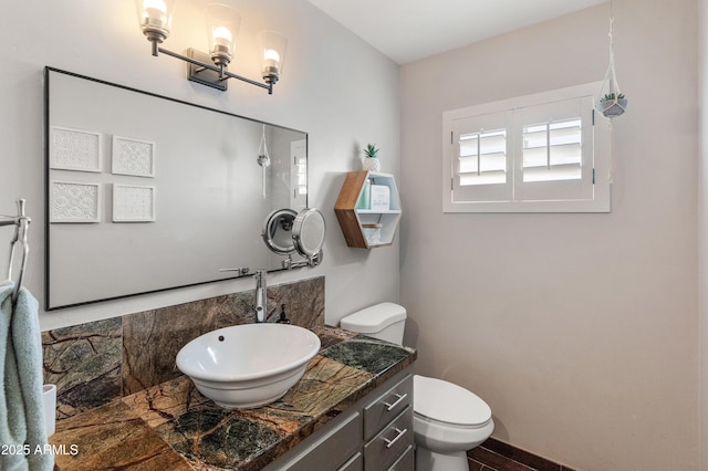 bathroom featuring toilet and vanity