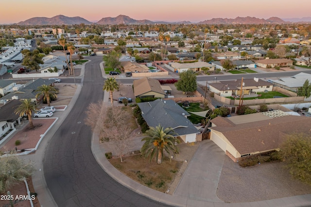 aerial view at dusk featuring a mountain view