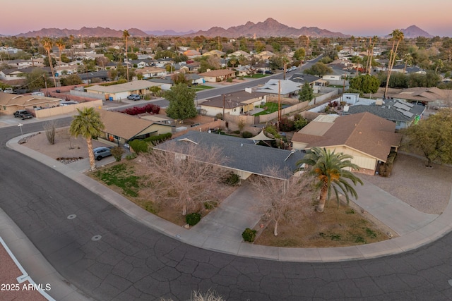 aerial view at dusk featuring a mountain view