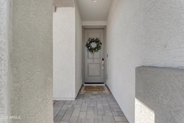 property entrance featuring stucco siding