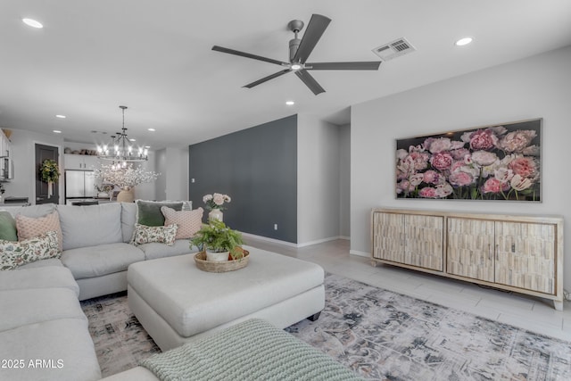 living room featuring recessed lighting, baseboards, ceiling fan with notable chandelier, and visible vents