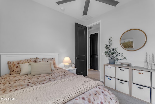 bedroom featuring visible vents, a ceiling fan, and light carpet