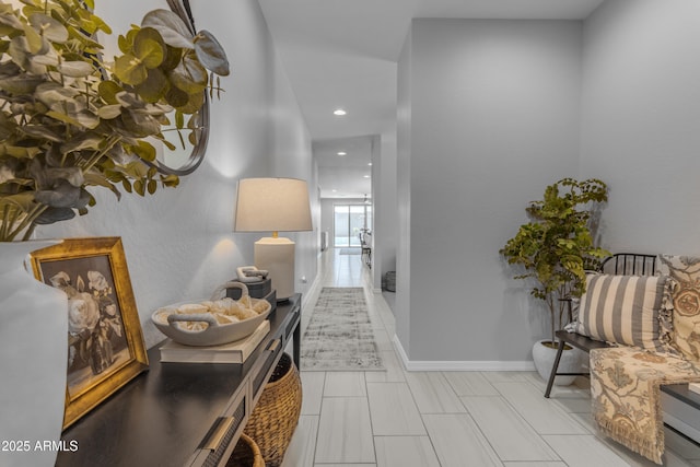 hall featuring recessed lighting and baseboards