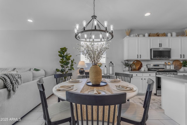 dining area featuring recessed lighting, light tile patterned floors, and a notable chandelier