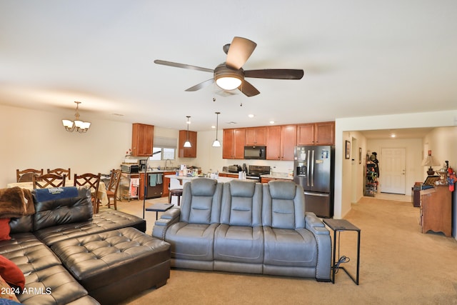 living room featuring light carpet, sink, and ceiling fan with notable chandelier