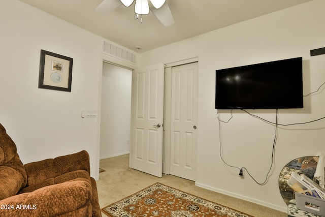 living room featuring light carpet and ceiling fan