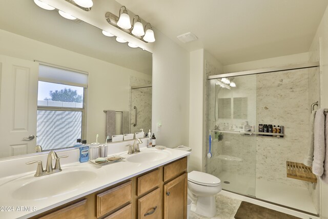 bathroom featuring dual vanity, walk in shower, tile flooring, and toilet