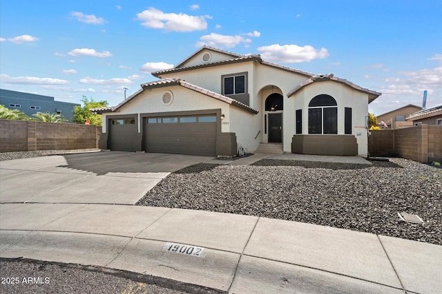 19002 N 25th Pl, Phoenix, AZ 85050 - mediterranean / spanish house featuring stucco siding, driveway, an attached garage, and a tiled roof