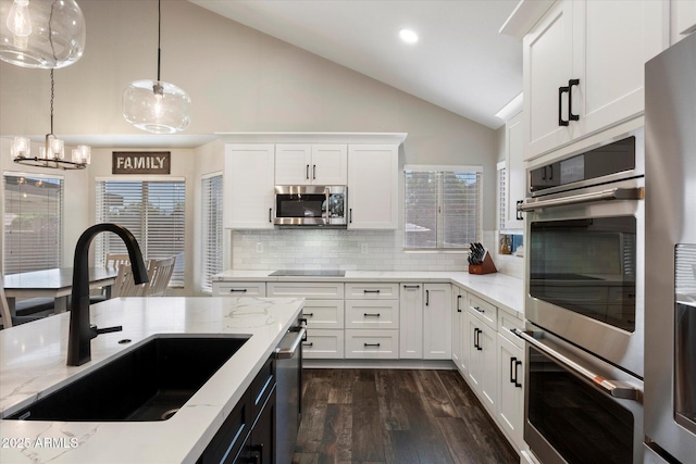 19002 N 25th Pl, Phoenix, AZ 85050 - kitchen featuring appliances with stainless steel finishes, dark wood-type flooring, backsplash, hanging light fixtures, and white cabinetry