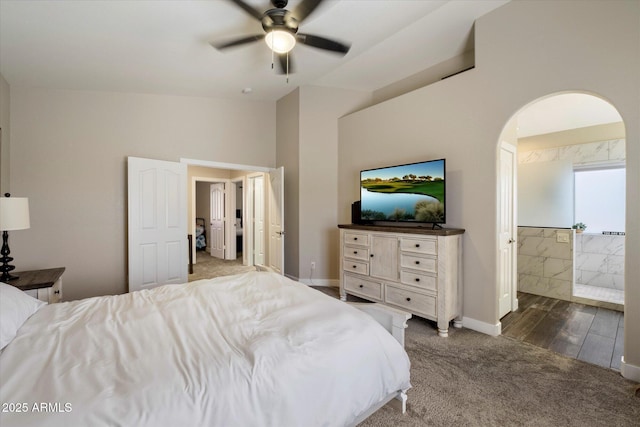 19002 N 25th Pl, Phoenix, AZ 85050 - bedroom featuring dark colored carpet, arched walkways, vaulted ceiling, ensuite bathroom, and a ceiling fan
