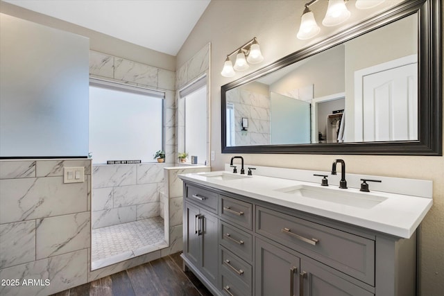 19002 N 25th Pl, Phoenix, AZ 85050 - bathroom featuring vaulted ceiling, walk in shower, double vanity, wood finished floors, and a closet