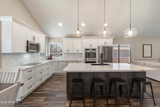 19002 N 25th Pl, Phoenix, AZ 85050 - kitchen featuring stainless steel appliances, vaulted ceiling, white cabinets, backsplash, and light stone counters