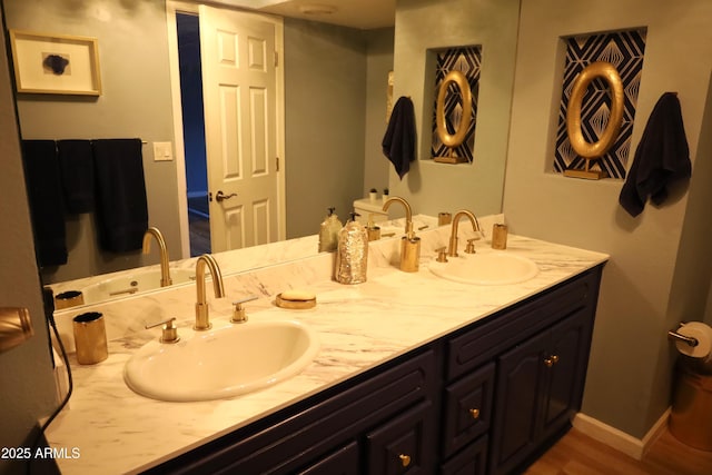 8848 N New World Dr, Glendale, AZ 85302 - bathroom featuring double vanity and wood finished floors