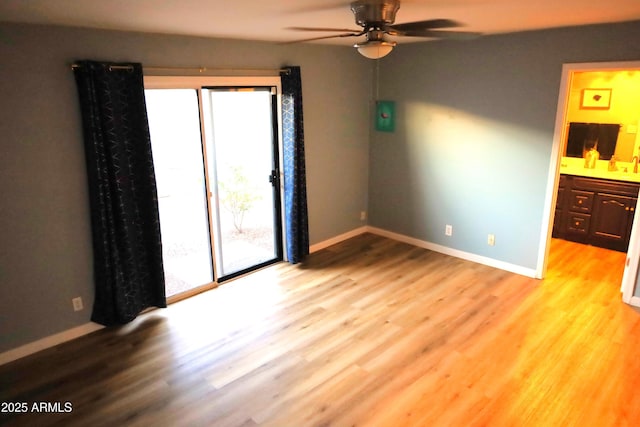 8848 N New World Dr, Glendale, AZ 85302 - unfurnished room featuring healthy amount of natural light, ceiling fan, and wood finished floors