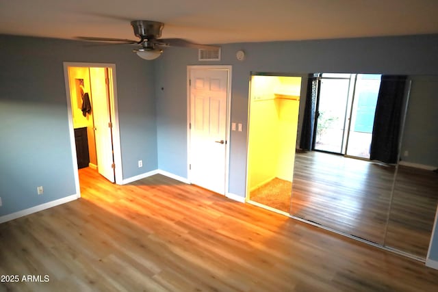 8848 N New World Dr, Glendale, AZ 85302 - unfurnished bedroom with wood finished floors, a spacious closet, and a closet