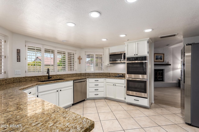400 W Crofton St, Chandler, AZ 85225 - kitchen featuring stainless steel appliances, white cabinetry, a textured ceiling, recessed lighting, and light tile patterned floors