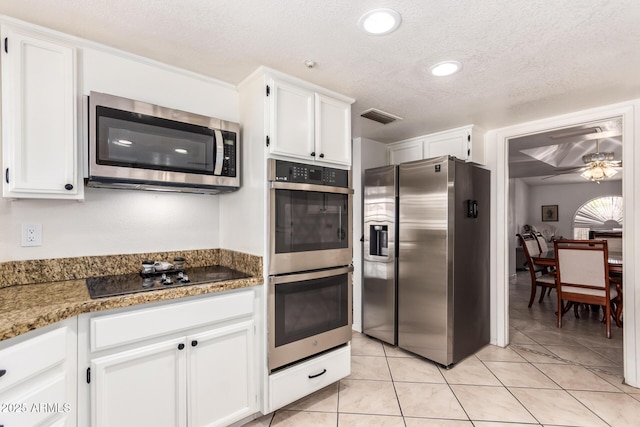 400 W Crofton St, Chandler, AZ 85225 - kitchen with appliances with stainless steel finishes, ceiling fan, white cabinets, a textured ceiling, and light tile patterned floors
