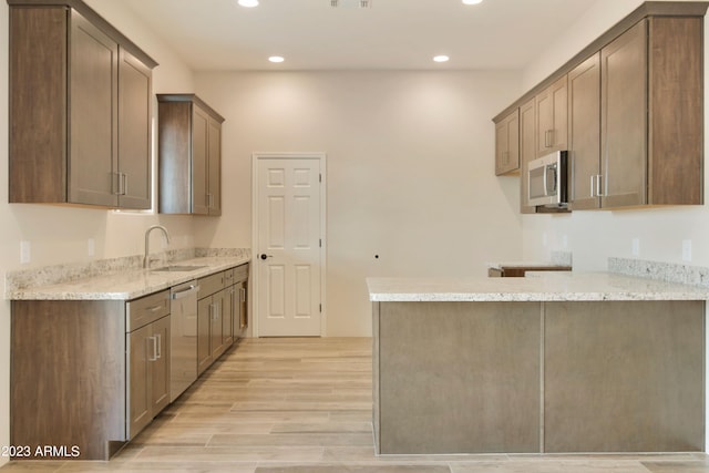 48111 N 7th Ave, New River, AZ 85087 - kitchen featuring light stone counters, sink, stainless steel appliances, and light wood-type flooring