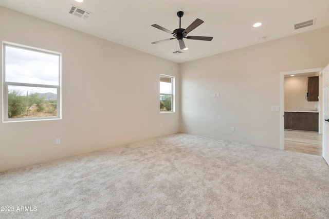 48111 N 7th Ave, New River, AZ 85087 - empty room featuring light colored carpet and ceiling fan