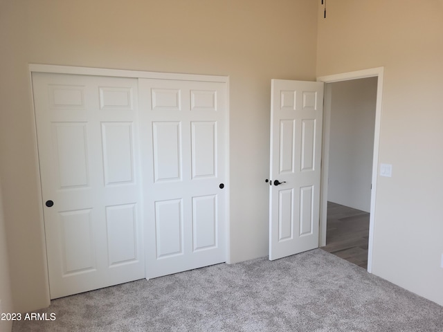 48111 N 7th Ave, New River, AZ 85087 - unfurnished bedroom with light colored carpet, a high ceiling, and a closet