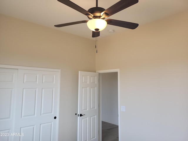 48111 N 7th Ave, New River, AZ 85087 - unfurnished bedroom with ceiling fan, a closet, and hardwood / wood-style flooring
