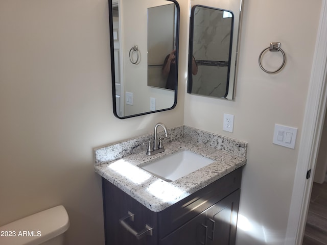 48111 N 7th Ave, New River, AZ 85087 - bathroom featuring hardwood / wood-style flooring, vanity, and toilet