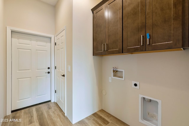 48111 N 7th Ave, New River, AZ 85087 - washroom featuring hookup for an electric dryer, cabinets, washer hookup, and light wood-type flooring