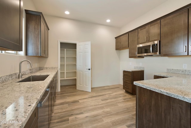 48111 N 7th Ave, New River, AZ 85087 - kitchen with light stone counters, sink, light wood-type flooring, and appliances with stainless steel finishes