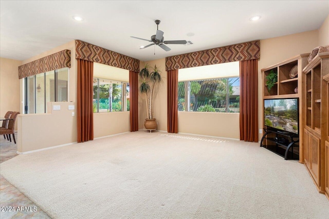 carpeted living room with ceiling fan