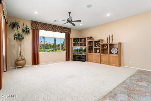 living room featuring ceiling fan and carpet