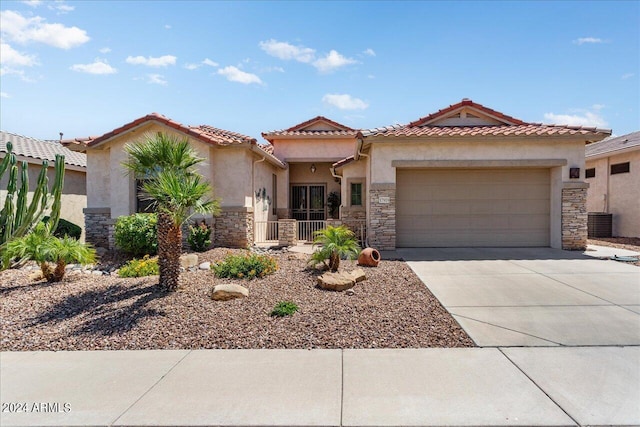 mediterranean / spanish-style home with cooling unit and a garage