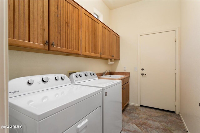 laundry room featuring washer and dryer, cabinets, and sink