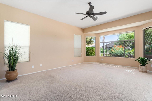 carpeted empty room featuring ceiling fan