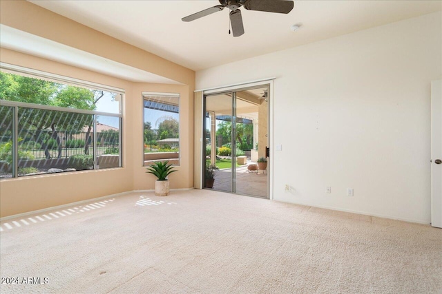 empty room with ceiling fan and carpet flooring