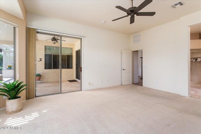 unfurnished room with ceiling fan and light colored carpet