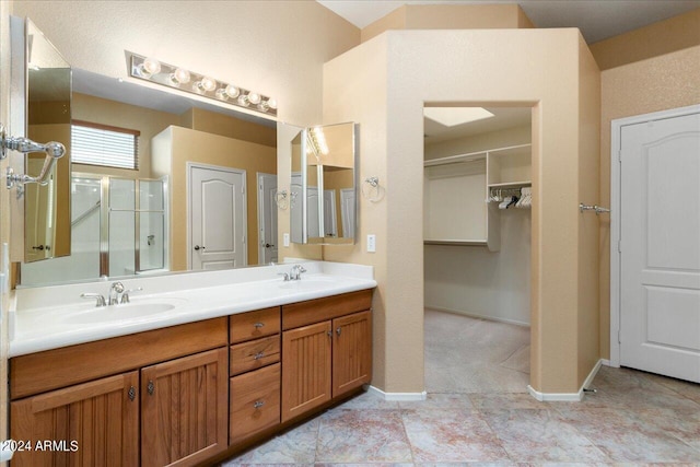 bathroom featuring an enclosed shower and vanity