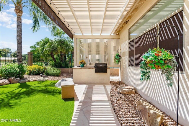 view of patio / terrace with a grill and a pergola