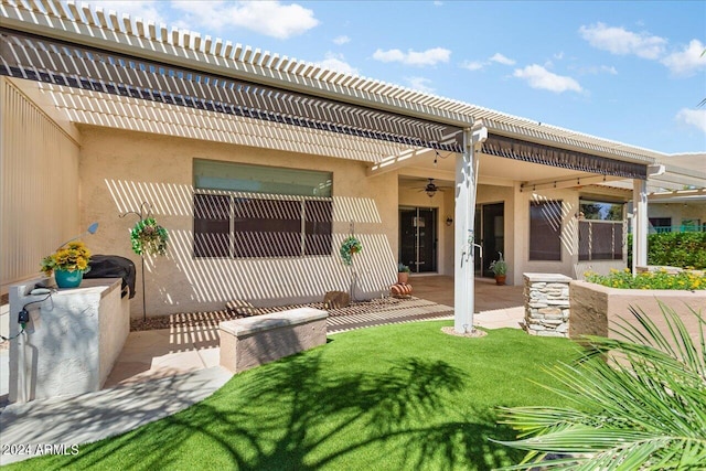 back of house with a lawn, ceiling fan, a pergola, and a patio