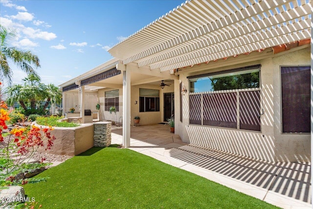 rear view of property featuring a patio area, a pergola, and a yard