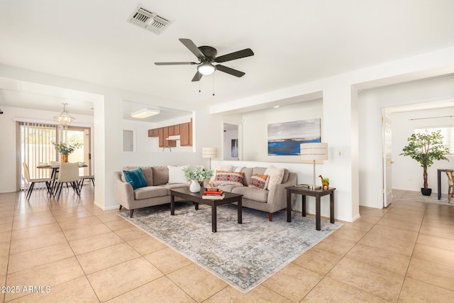 living room with light tile patterned floors, visible vents, and a ceiling fan