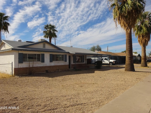 single story home featuring a carport