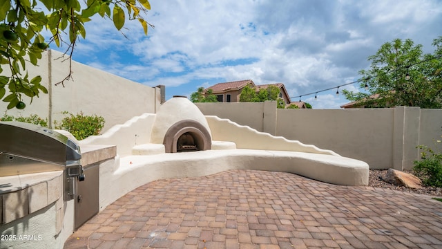 view of patio with fence and area for grilling