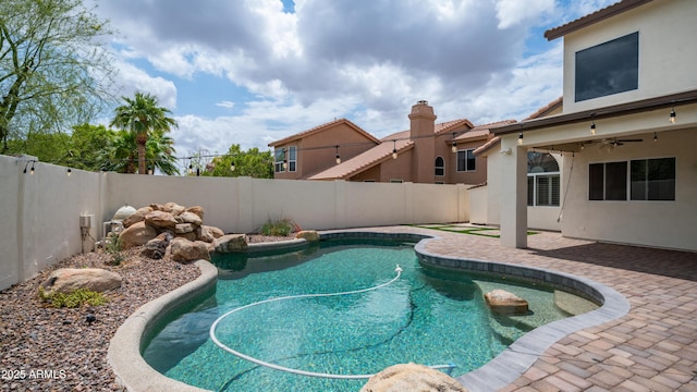 view of pool featuring a fenced backyard, a patio area, and ceiling fan