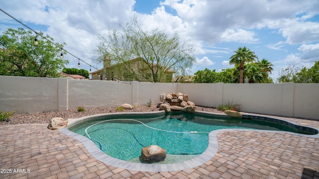 view of pool featuring a fenced backyard and a patio