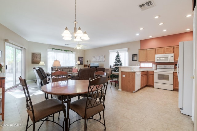 dining space with recessed lighting, visible vents, plenty of natural light, and an inviting chandelier